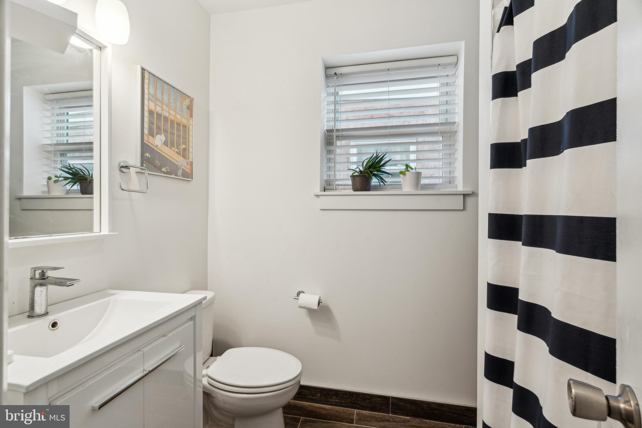 1319 Tasker Street Philadelphia, PA 19148 - Photo 15 of 23 a bathroom with a sink a toilet and a shower