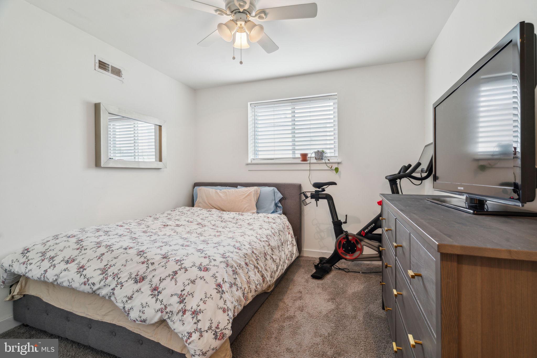 1319 Tasker Street Philadelphia, PA 19148 - Photo 18 of 23 a bedroom with a bed and a flat screen tv