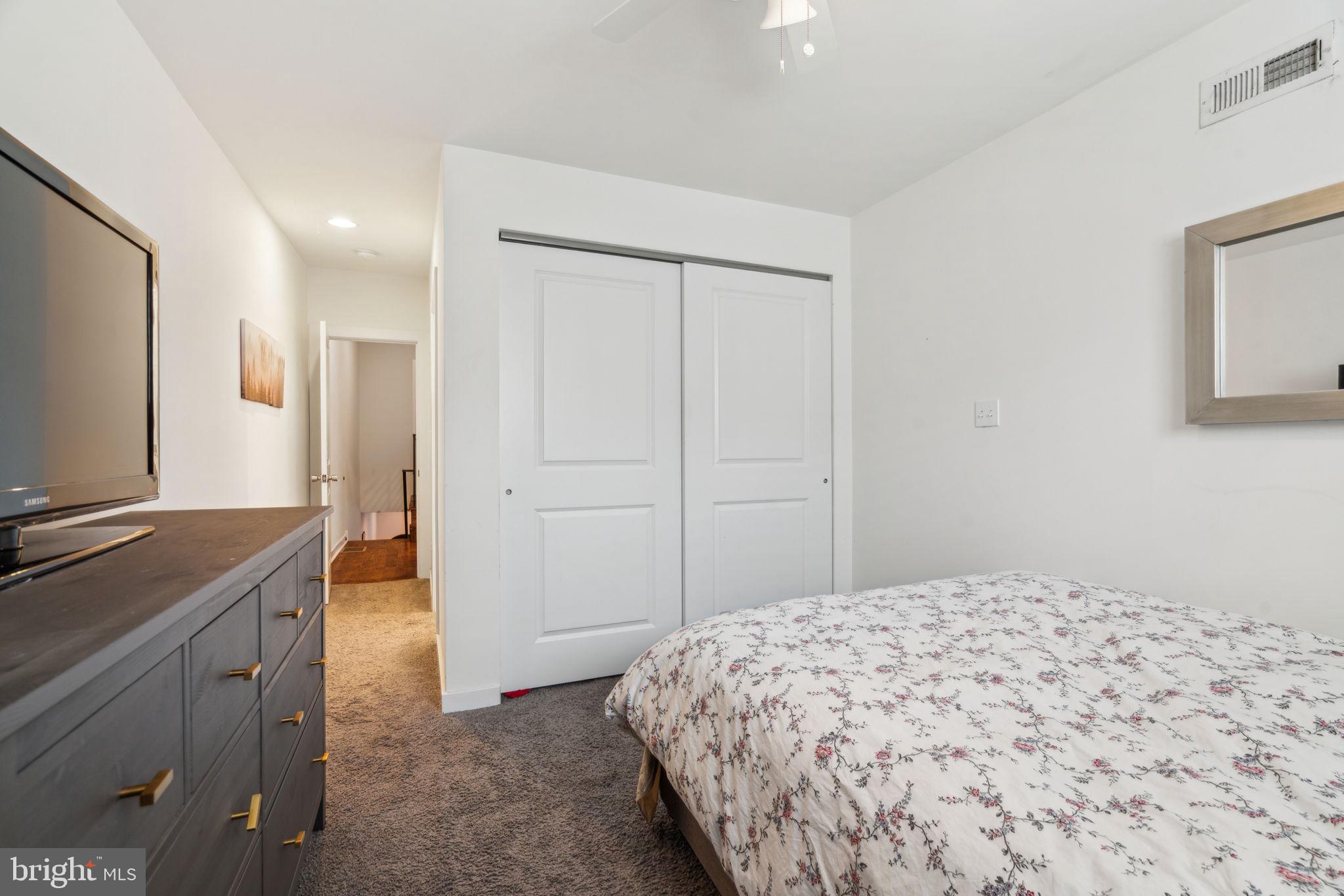 1319 Tasker Street Philadelphia, PA 19148 - Photo 19 of 23 a bedroom with a bed and a flat screen tv