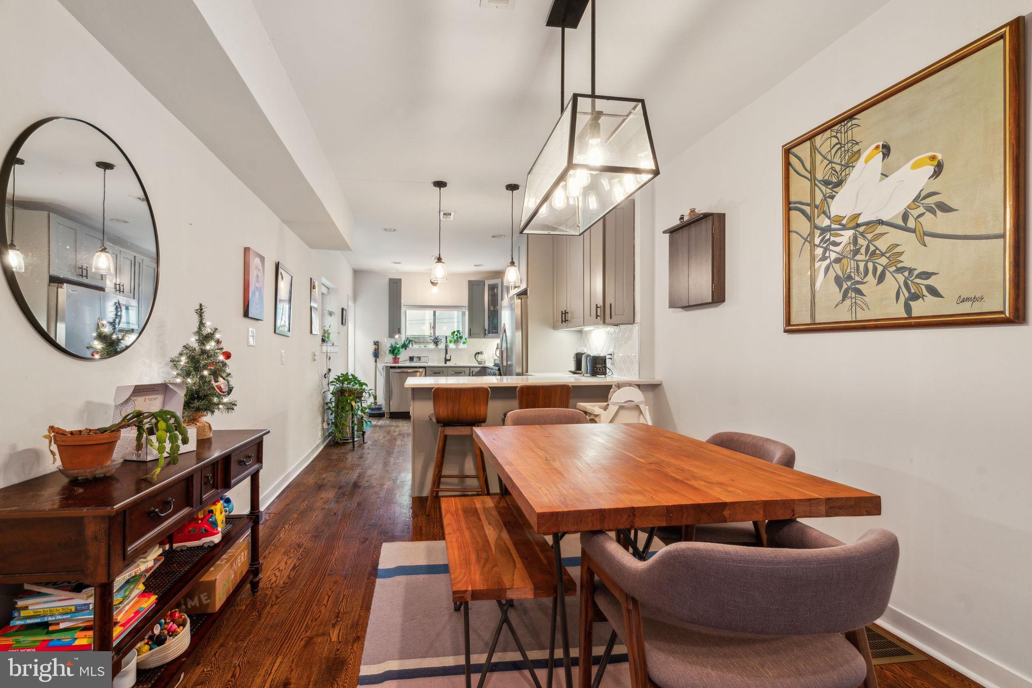 1319 Tasker Street Philadelphia, PA 19148 - Photo 5 of 23 a view of a dining room with furniture and a chandelier