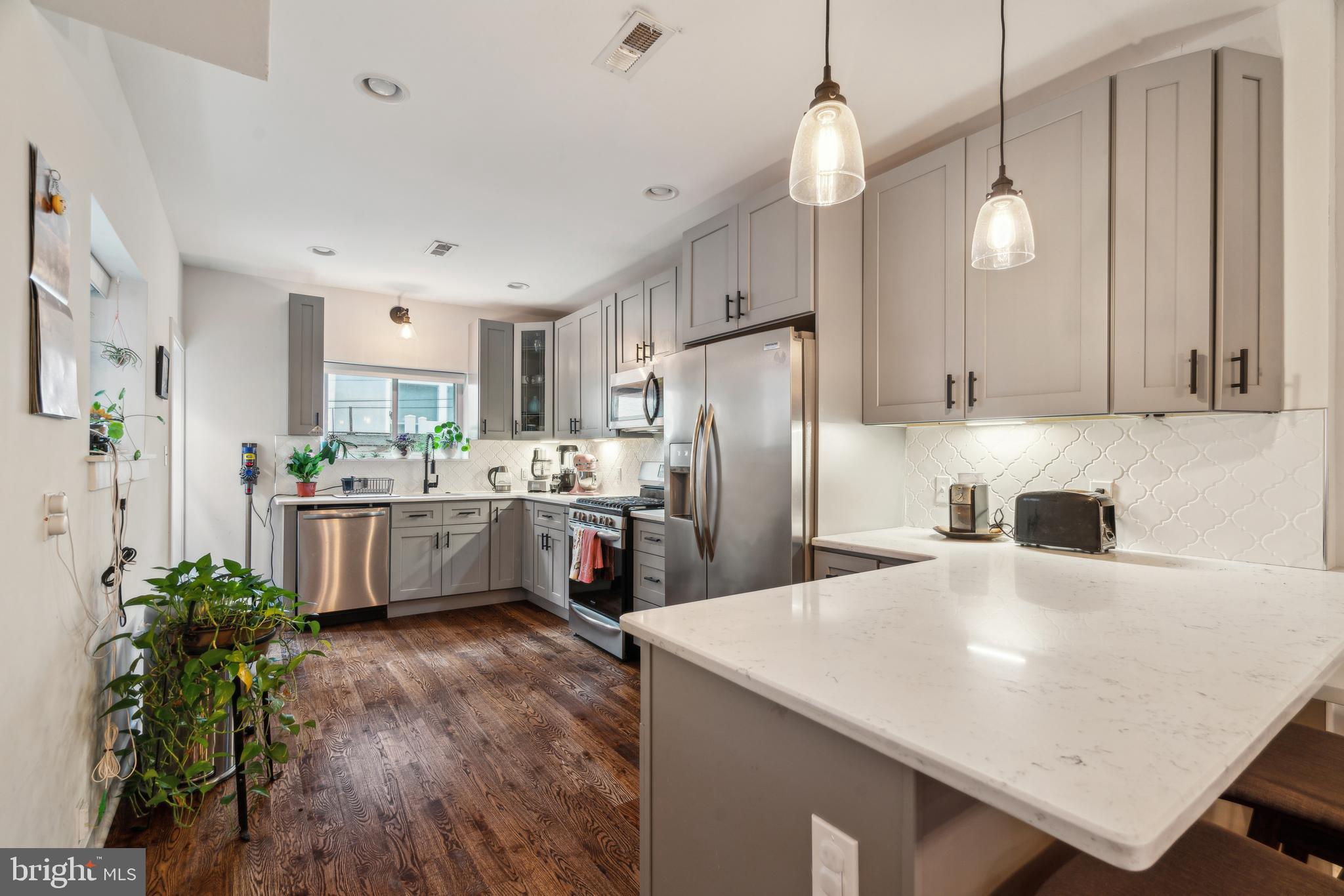 1319 Tasker Street Philadelphia, PA 19148 - Photo 6 of 23 a kitchen with counter top space cabinets and stainless steel appliances