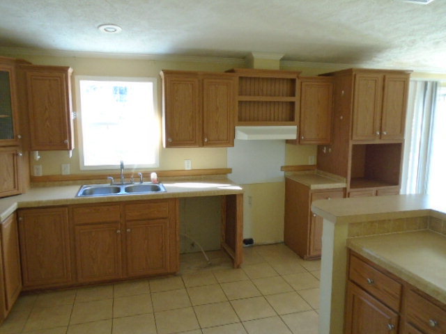 825 Old Indian Springs Road Forsyth, GA 31029 - Photo 4 of 21 a kitchen with a sink cabinets and window