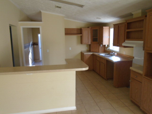 825 Old Indian Springs Road Forsyth, GA 31029 - Photo 5 of 21 a kitchen with stainless steel appliances granite countertop a sink counter space and cabinets