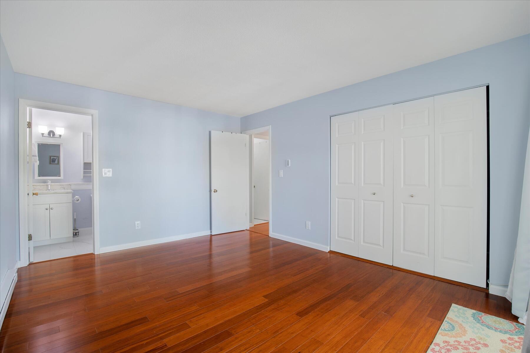 800 Bearses Way, Unit 1EB Hyannis, MA 02601 - Photo 22 of 37 a view of an empty room with wooden floor and a bathroom