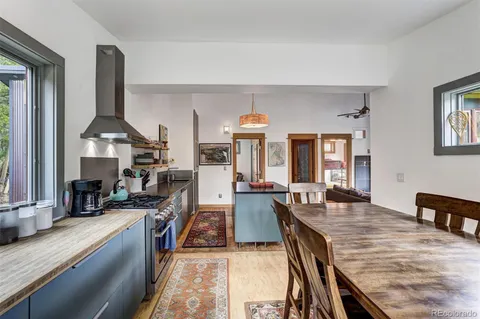 a kitchen with sink a stove and chairs