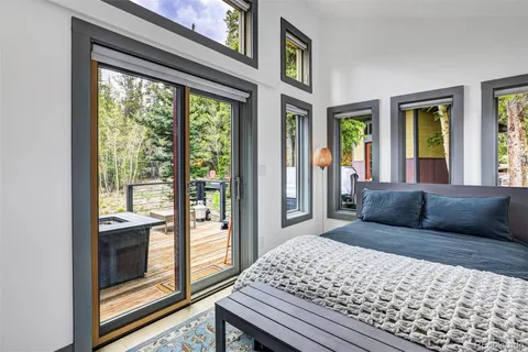 a bedroom with a large bed and a balcony view