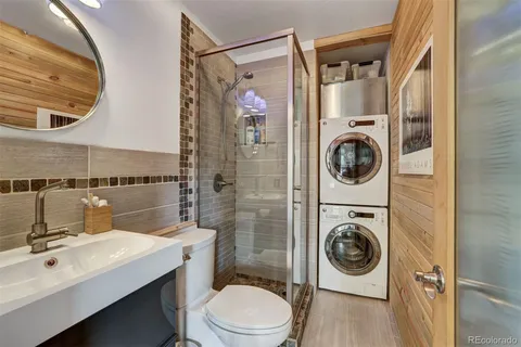 a bathroom with a sink a mirror and toilet