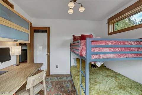 a bathroom with a granite countertop sink a mirror and shower