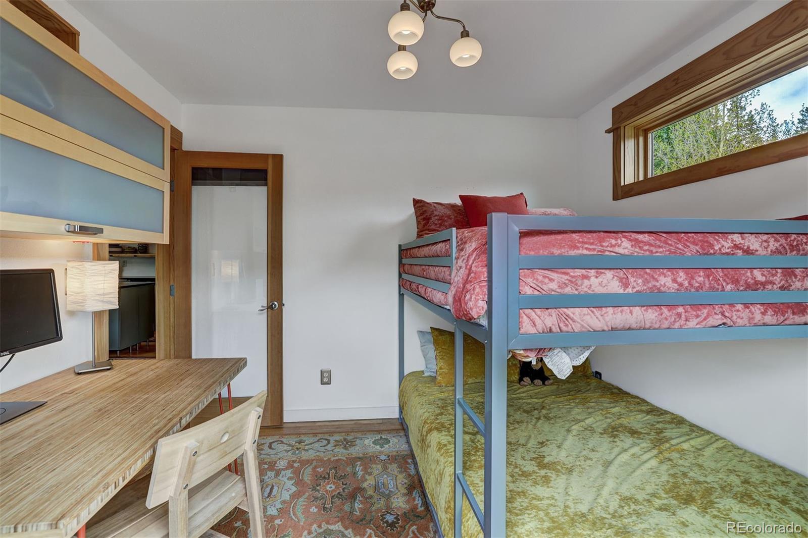 3049 County Road 6 Alma, CO 80420 - Photo 23 of 43 a bathroom with a granite countertop sink a mirror and shower