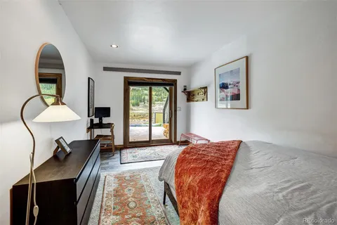 a bedroom with bed and a large window