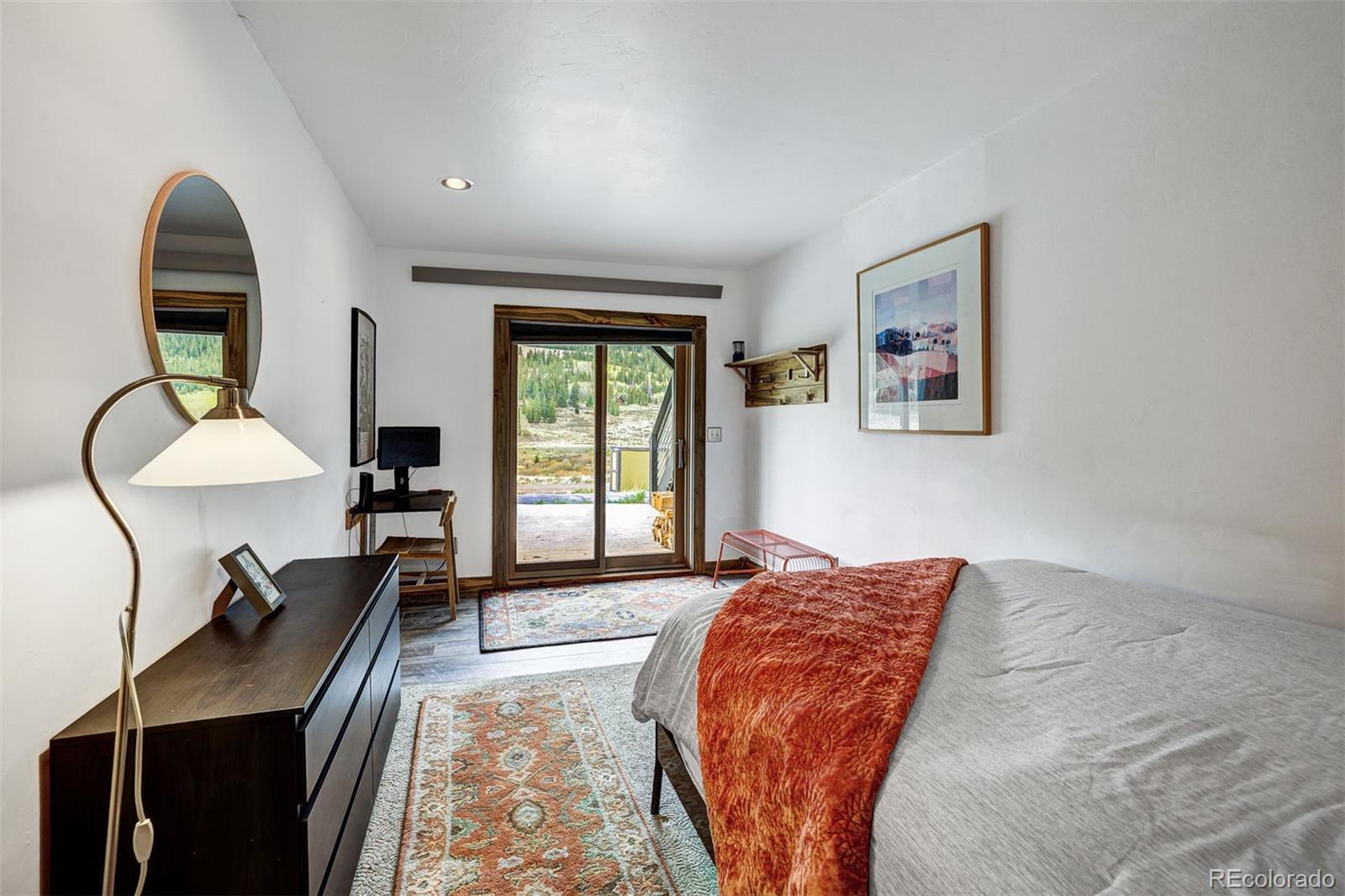 3049 County Road 6 Alma, CO 80420 - Photo 25 of 43 a bedroom with bed and a large window