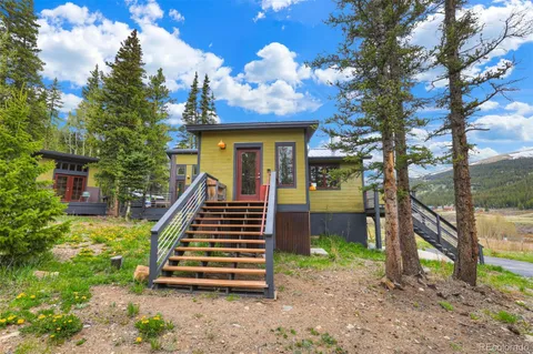 a view of a house with backyard porch and sitting area