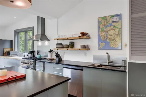 a kitchen with sink refrigerator and cabinets