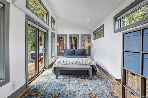 a living room with a bed furniture and a large window