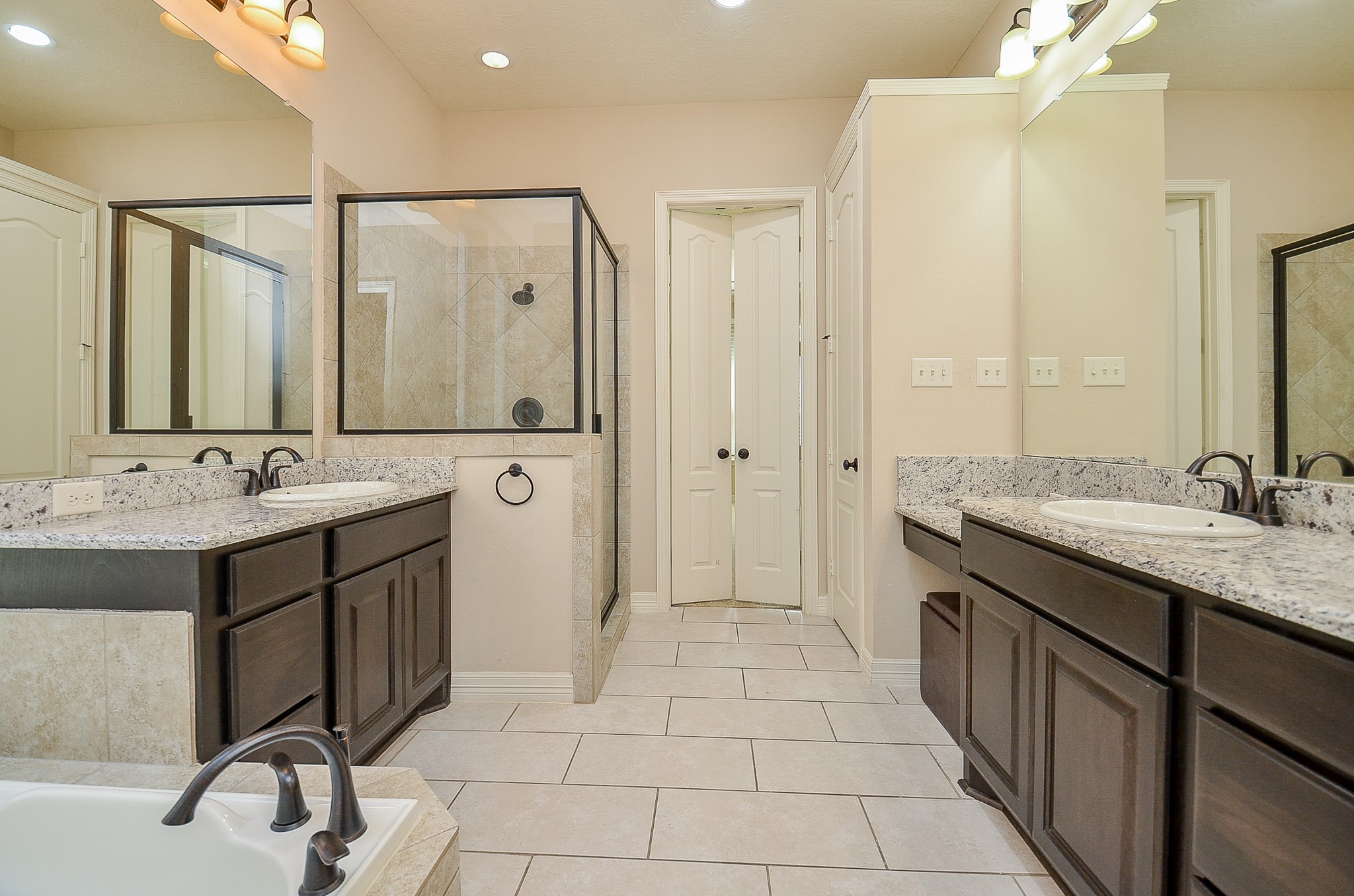 27914 Hunters Rock Lane Katy, TX 77494 - Photo 15 of 32 a spacious bathroom with a shower sink and mirror