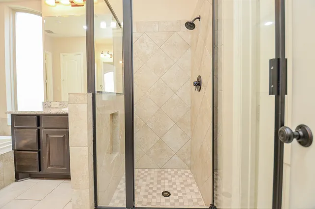a bathroom with a shower and a sink