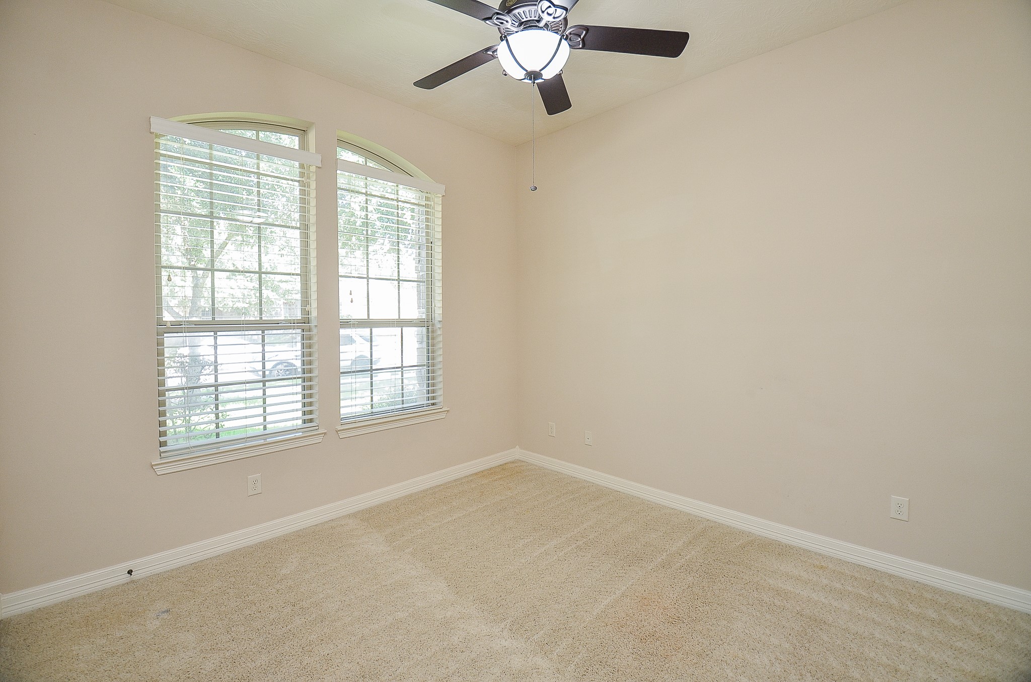 27914 Hunters Rock Lane Katy, TX 77494 - Photo 18 of 32 an empty room with a window and a fan