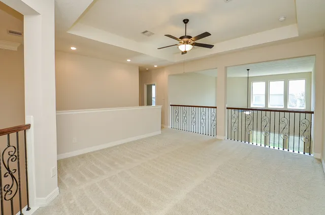 a view of a livingroom with a ceiling fan and window