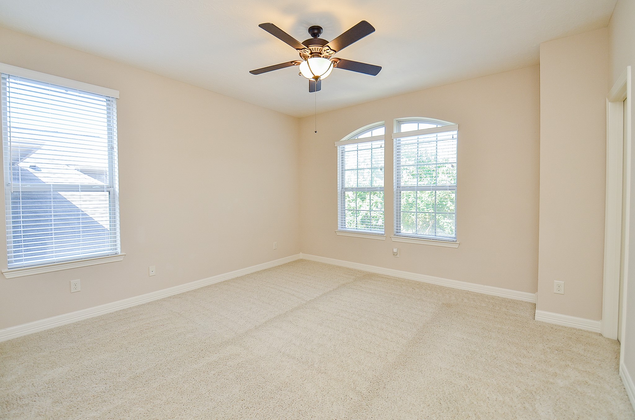 27914 Hunters Rock Lane Katy, TX 77494 - Photo 23 of 32 an empty room with windows and fan