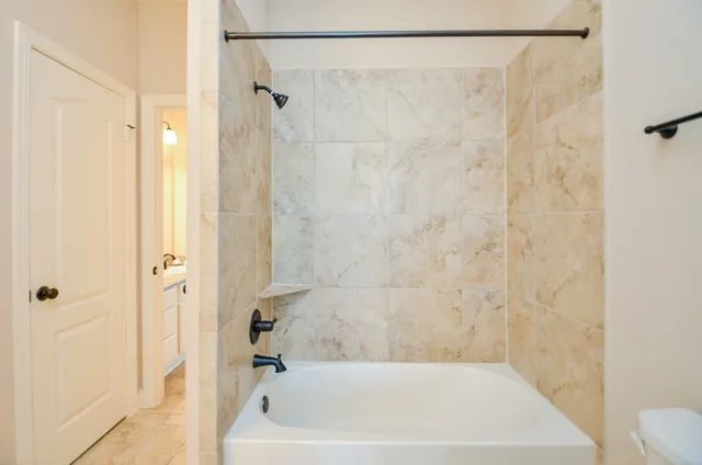 a bathroom with a shower and a bath tub