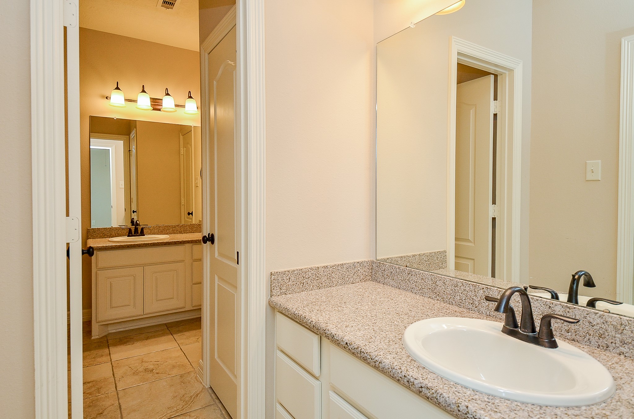 27914 Hunters Rock Lane Katy, TX 77494 - Photo 26 of 32 a bathroom with a granite countertop sink and a mirror