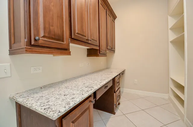 a view of kitchen island with wooden cabinets