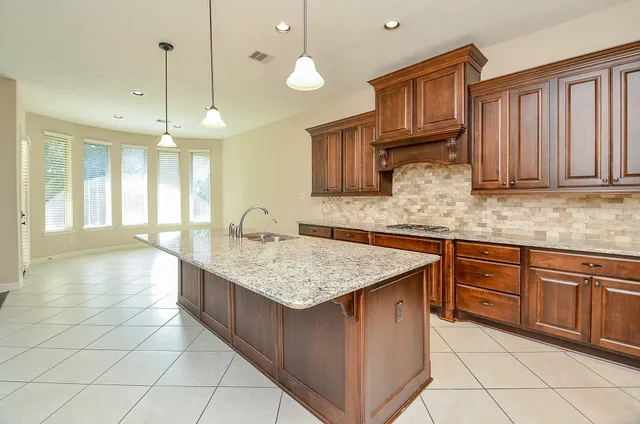 a kitchen with cabinets and chandelier