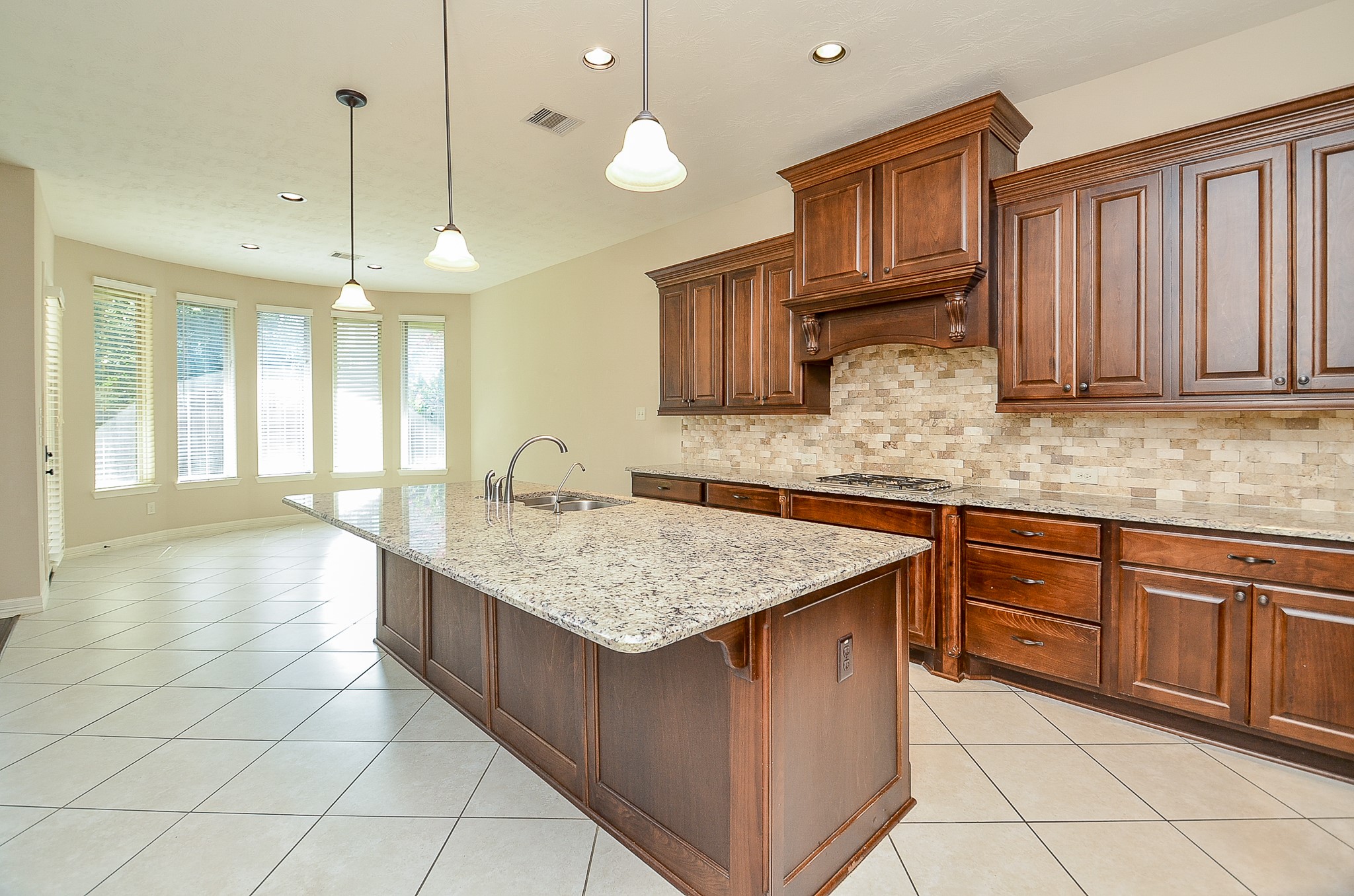 27914 Hunters Rock Lane Katy, TX 77494 - Photo 10 of 32 a kitchen with cabinets and chandelier