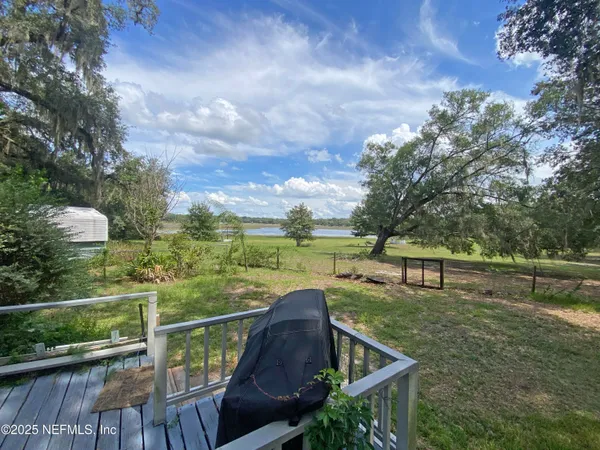 a view of a terrace with couches and wooden fence