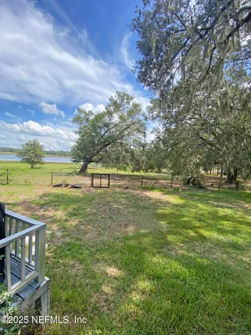 a view of a green yard with a house