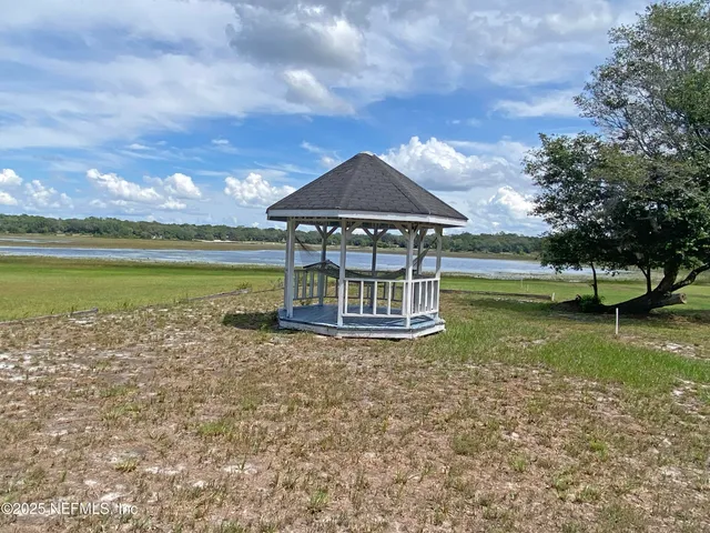 a view of a garden with a table under an umbrella