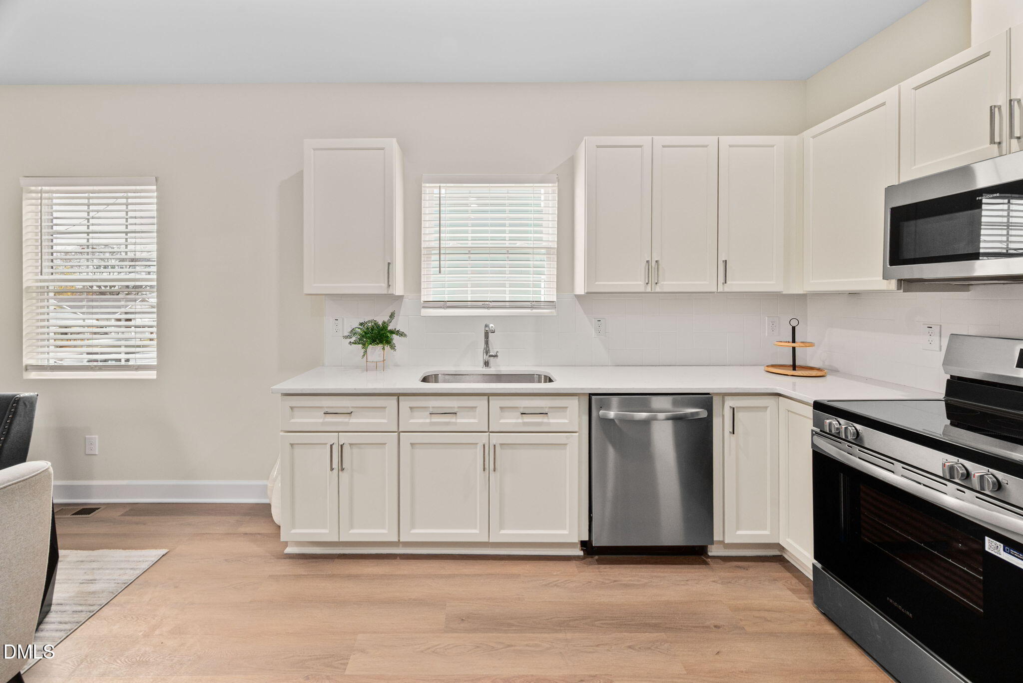 1106 South Blount Street Raleigh, NC 27601 - Photo 6 of 33 a kitchen with stainless steel appliances granite countertop a sink a stove a microwave and cabinets