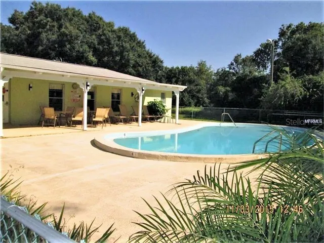 a view of a house with pool and yard