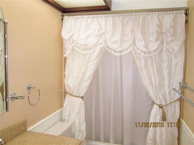 a bathroom with a shower curtain and a curtain
