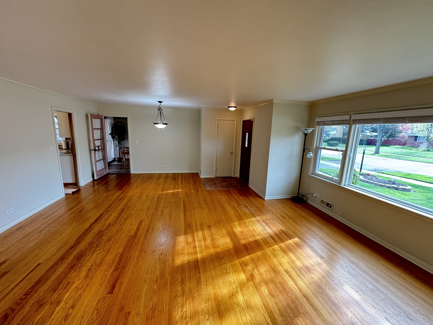 901 Brookline Lane Park Ridge, IL 60068 - Photo 3 of 23 a view of an empty room with a window and wooden floor