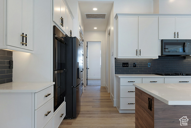 3145 Snow Cyn Road Hurricane, UT 84737 - Photo 9 of 38 Kitchen featuring decorative backsplash, light wood-style flooring, black appliances, light countertops, and recessed lighting