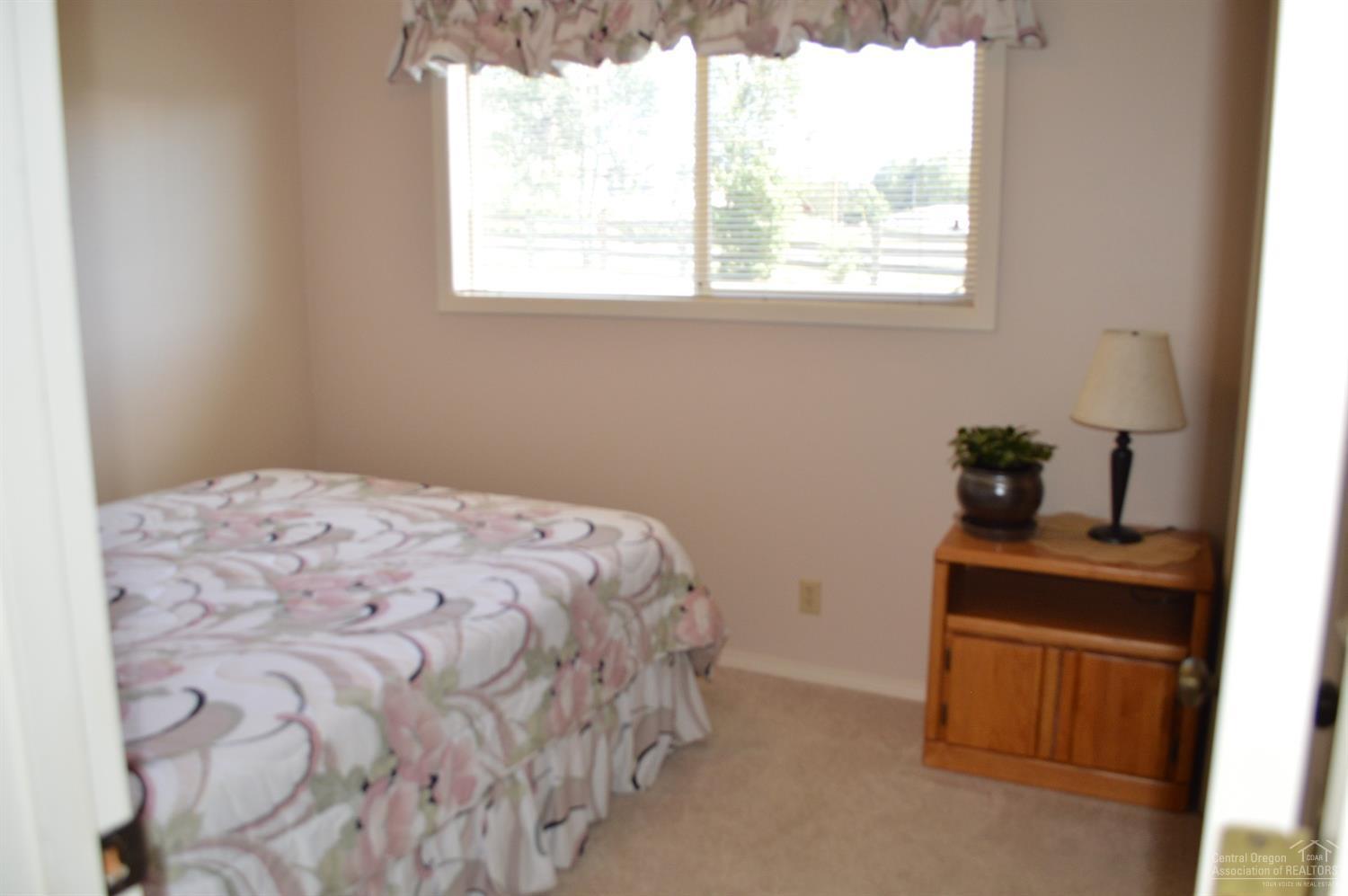 61835 Dobbin Road Bend, OR 97702 - Photo 10 of 23 a bedroom with a bed and a window