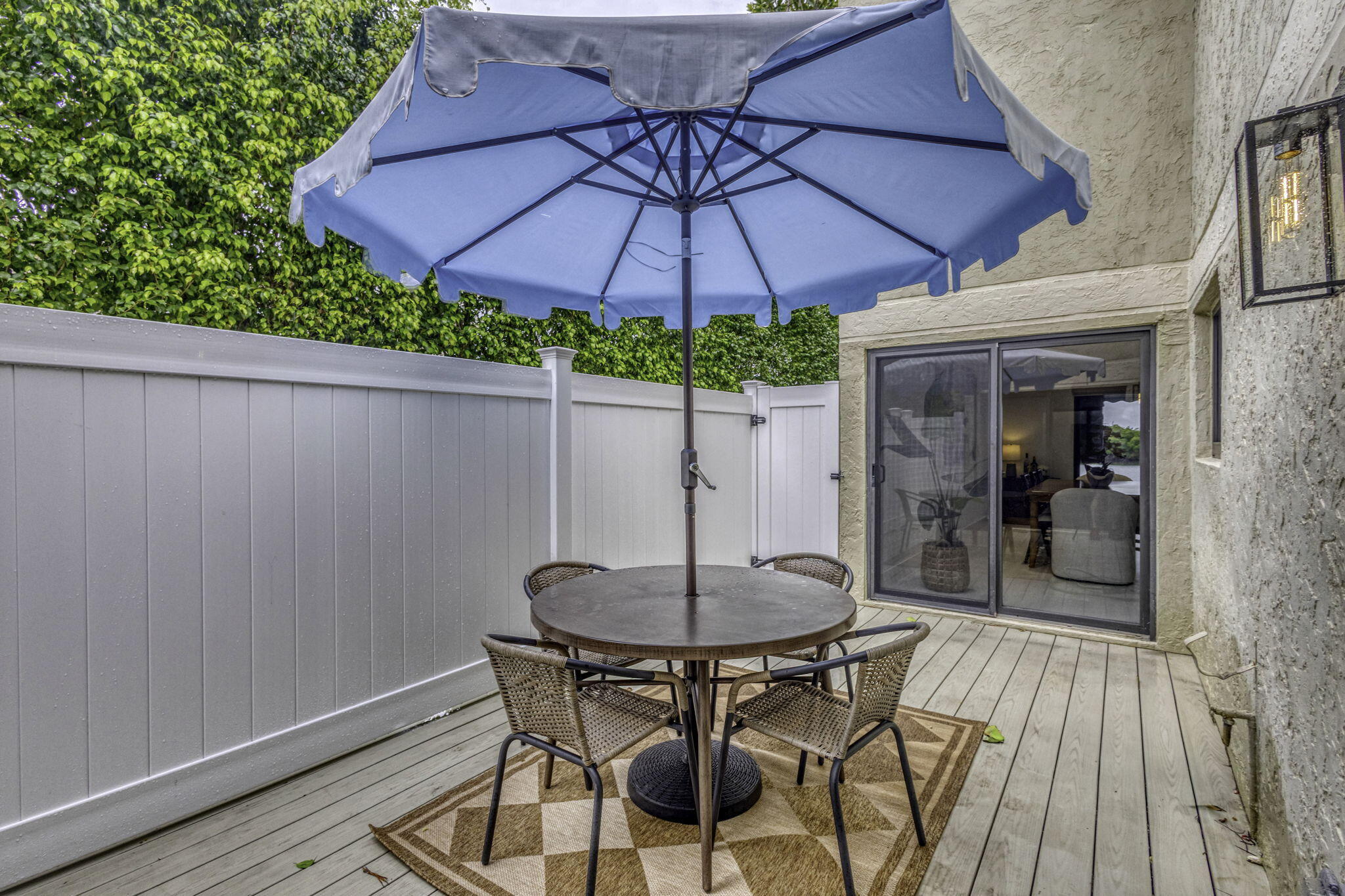 6550 North Ocean Boulevard, Unit 1 Ocean Ridge, FL 33435 - Photo 47 of 63 a patio with a table and chairs under an umbrella