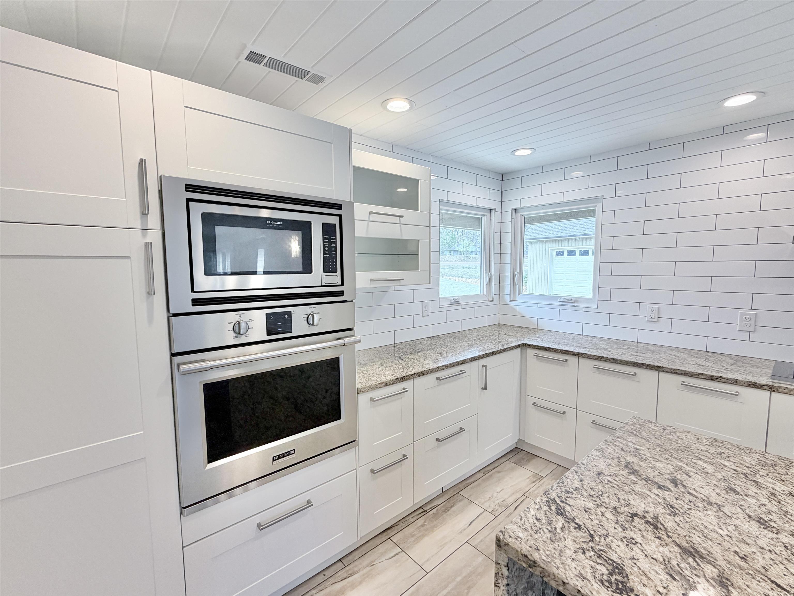 955 Country Club Road Somerville, TN 38068 - Photo 15 of 40 Kitchen with stainless steel appliances, light stone countertops, white cabinets, recessed lighting, and wooden ceiling