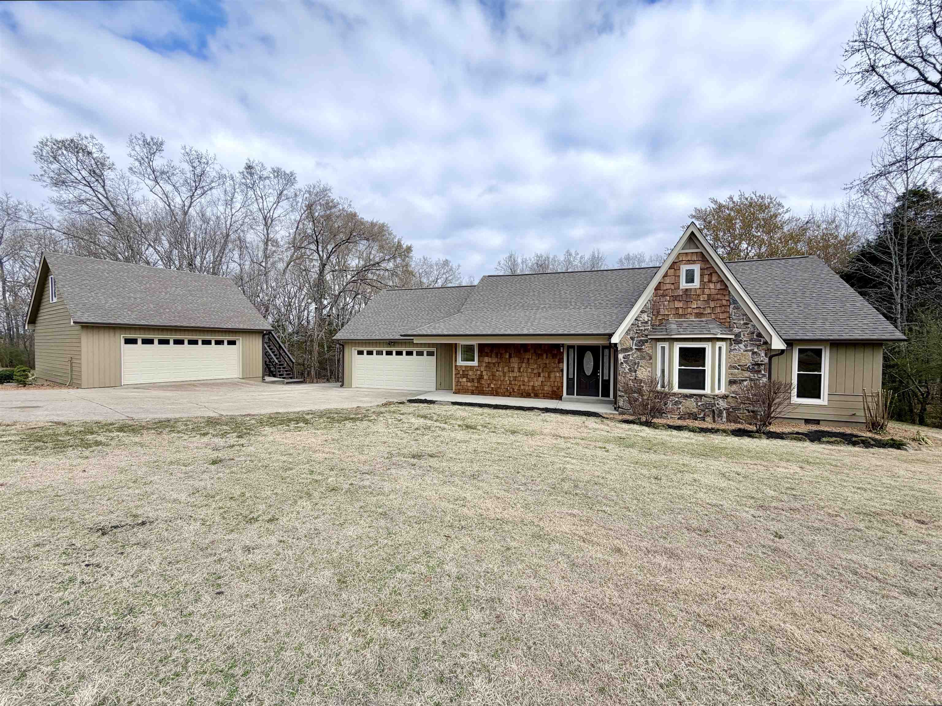955 Country Club Road Somerville, TN 38068 - Photo 2 of 40 View of front facade featuring roof with shingles, crawl space, stone siding, and a front lawn