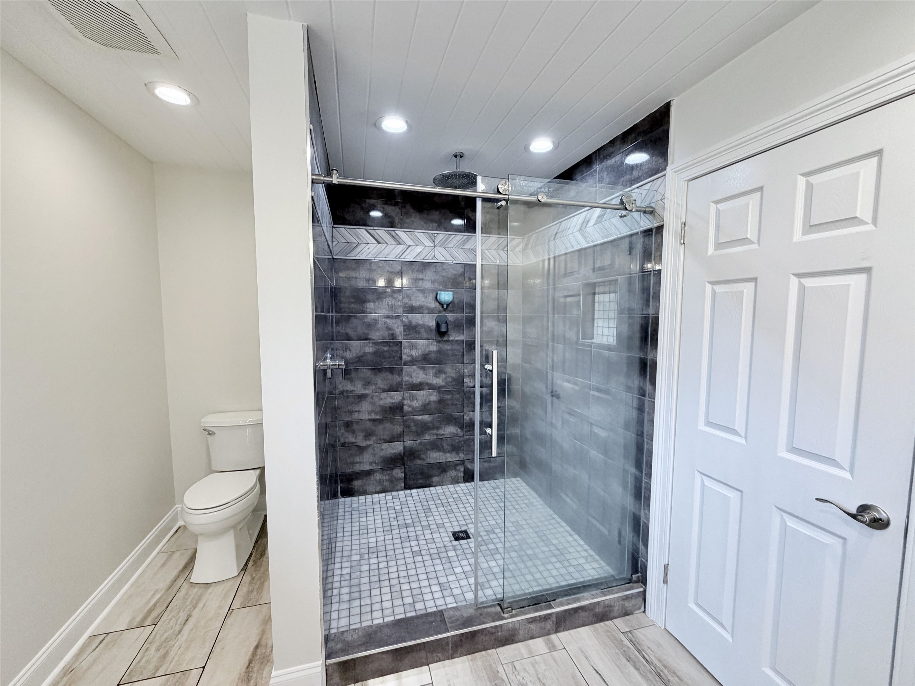 955 Country Club Road Somerville, TN 38068 - Photo 22 of 40 Full bathroom with a stall shower, recessed lighting, and wood finish floors