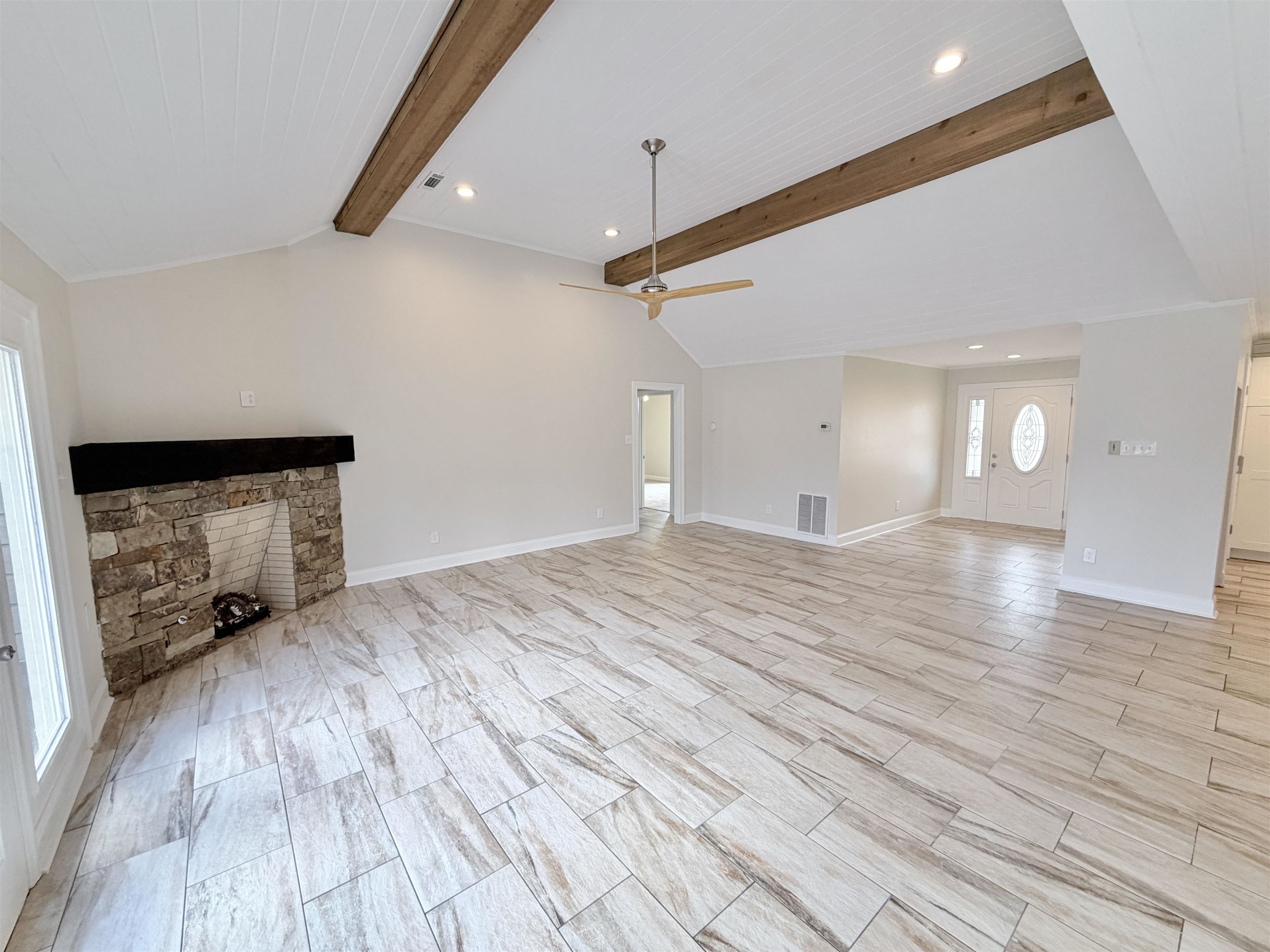 955 Country Club Road Somerville, TN 38068 - Photo 10 of 40 Unfurnished living room with recessed lighting, a ceiling fan, beamed ceiling, a fireplace, and wood finish floors