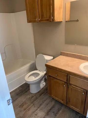 a bathroom with a toilet a sink and bathtub