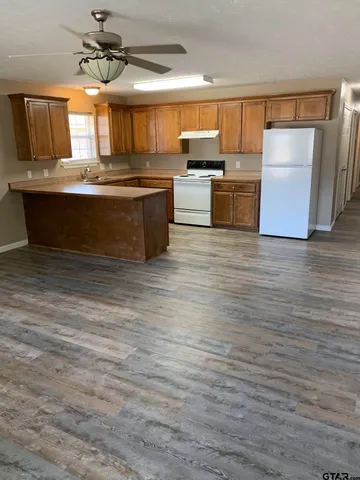 a kitchen with stainless steel appliances granite countertop a sink and a microwave