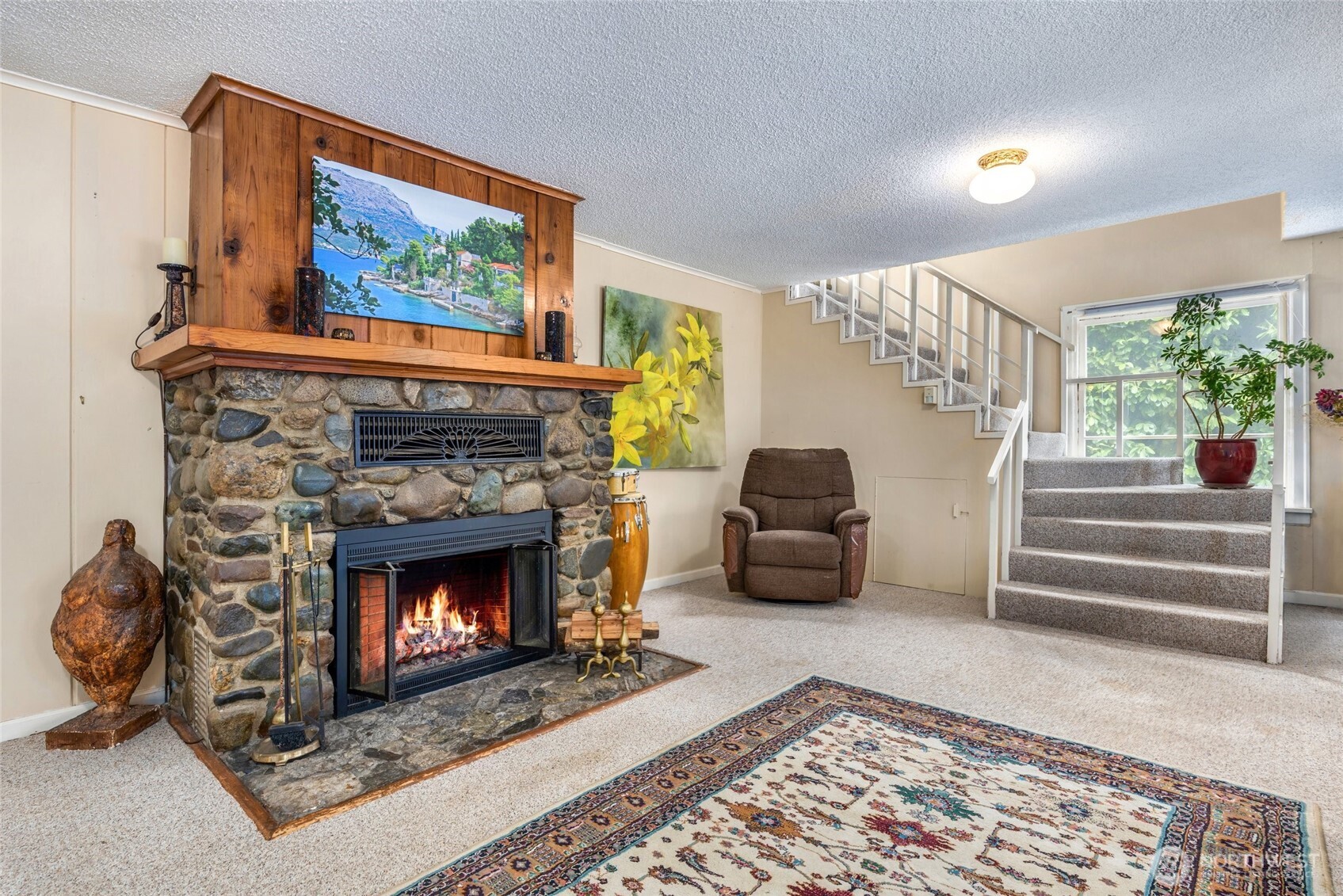 23606 Tiger Mountain Road Southeast Issaquah, WA 98027 - Photo 16 of 39 a living room with furniture and a fireplace