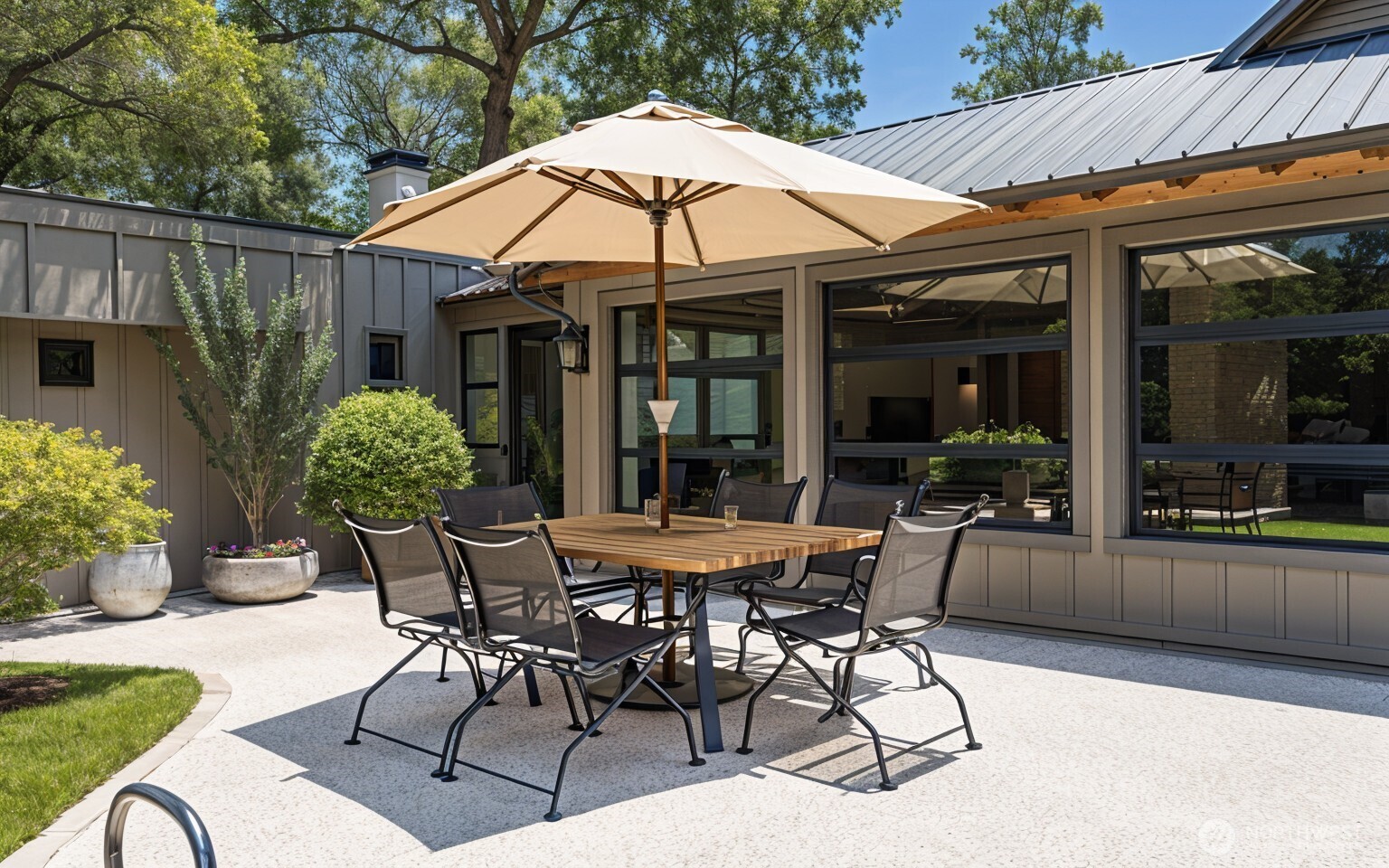 23606 Tiger Mountain Road Southeast Issaquah, WA 98027 - Photo 4 of 39 a patio with a table and chairs under an umbrella