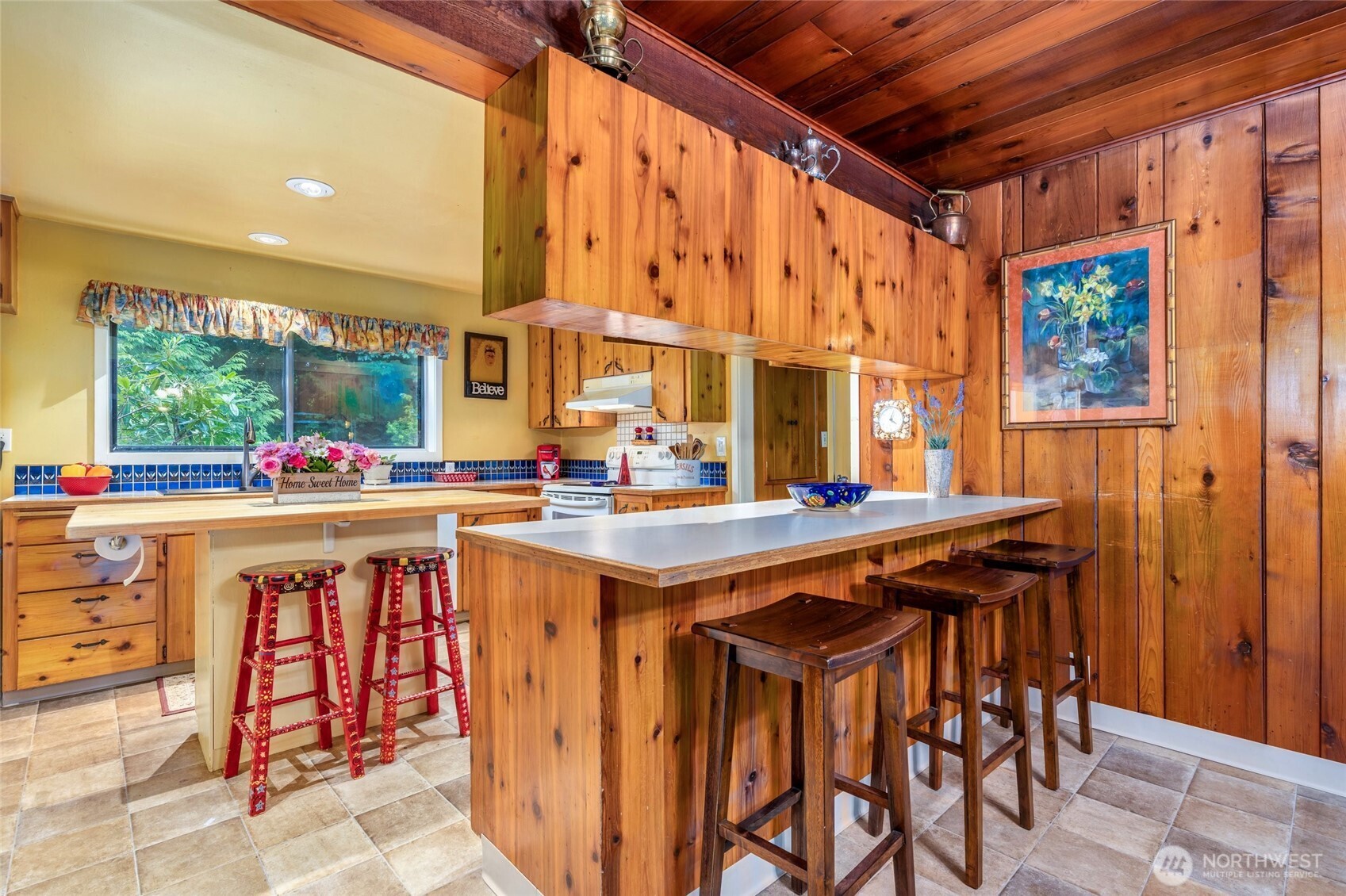 23606 Tiger Mountain Road Southeast Issaquah, WA 98027 - Photo 7 of 39 a table with chairs in it and wooden cabinets