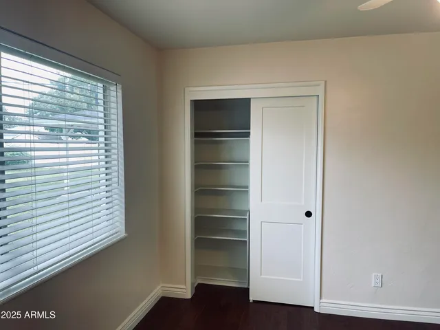 a view of walk in closet with empty racks