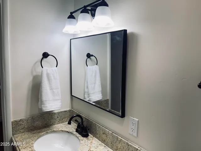 a bathroom with a sink and a mirror