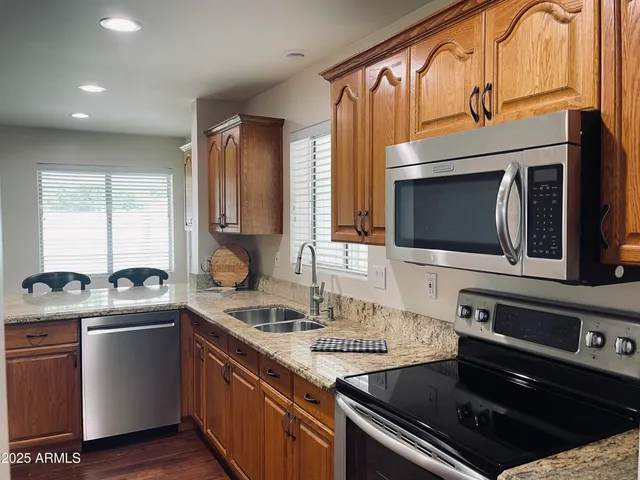 a kitchen with a sink stove and microwave